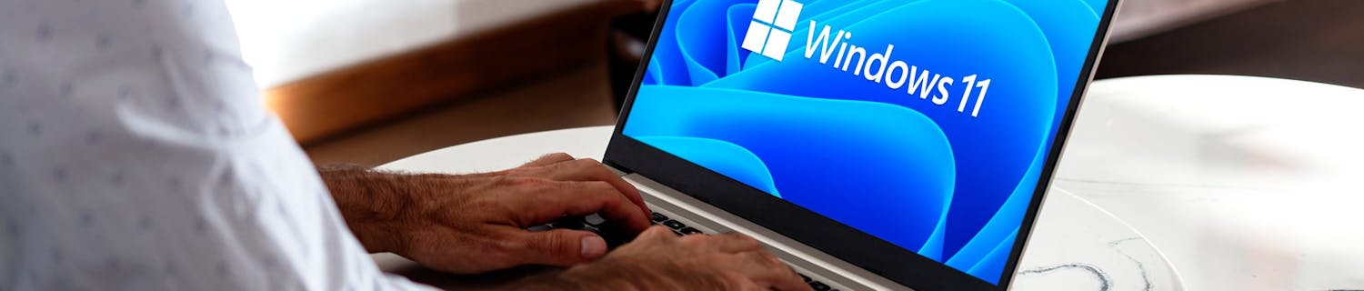 Windows,11,Logo,On,The,Laptop,Screen.,User,With,The